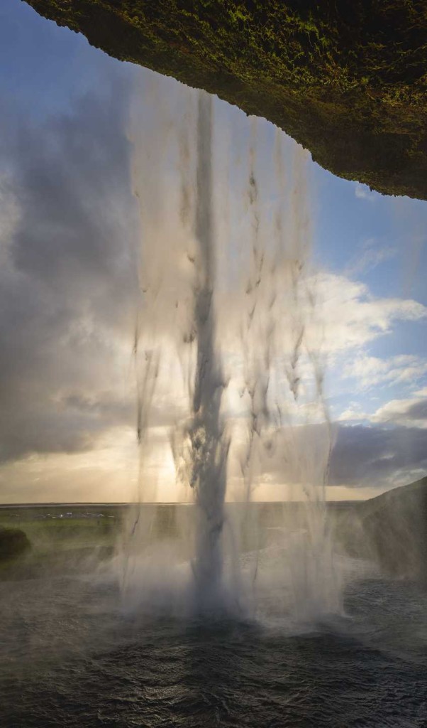 Standing behind Seljalandsfoss at sunset